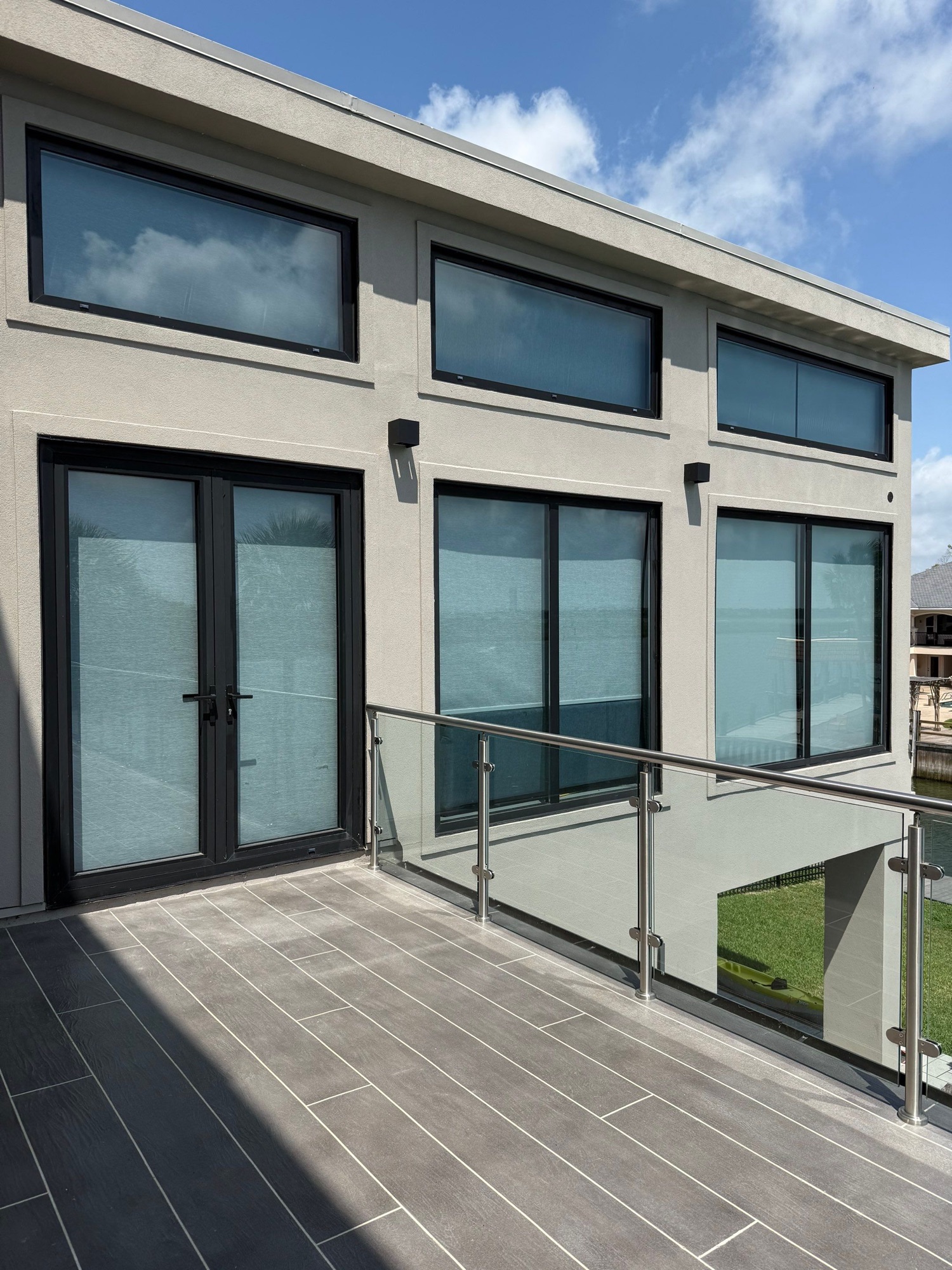 Detailed stucco exterior surrounding modern windows and a balcony